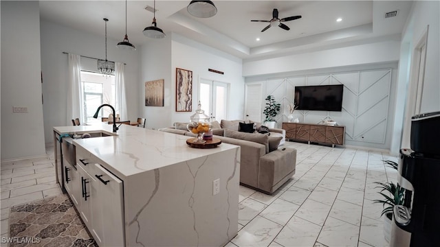 kitchen featuring a kitchen island with sink, recessed lighting, visible vents, open floor plan, and marble finish floor