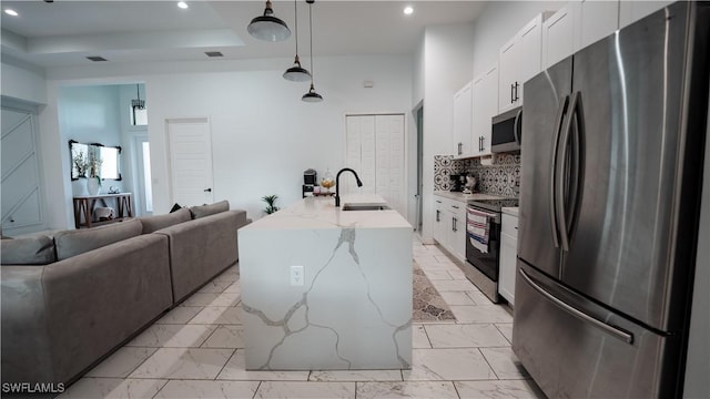 kitchen with stainless steel appliances, a sink, white cabinets, marble finish floor, and tasteful backsplash