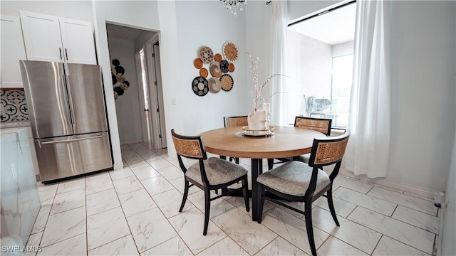 dining area featuring marble finish floor