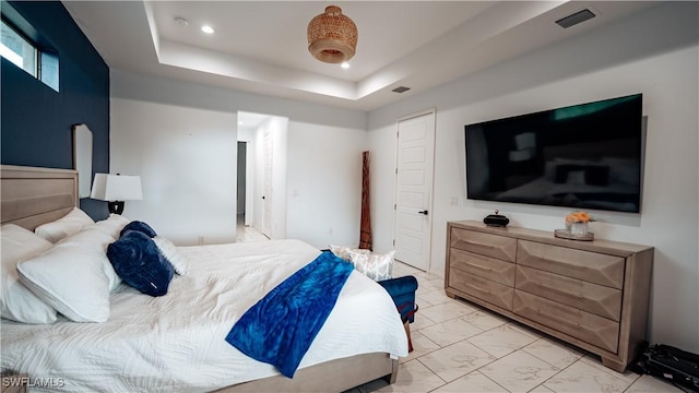 bedroom featuring marble finish floor, visible vents, a tray ceiling, and recessed lighting