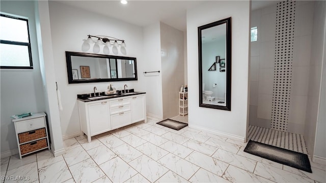 full bathroom with a walk in shower, recessed lighting, vanity, baseboards, and marble finish floor