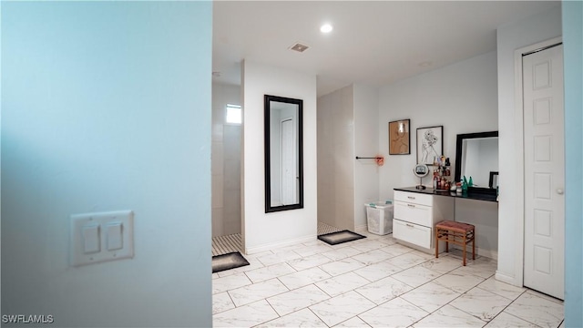 hall with recessed lighting, marble finish floor, visible vents, and baseboards