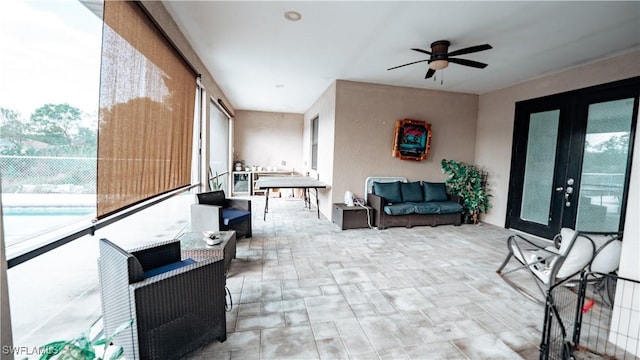 interior space featuring ceiling fan, french doors, and plenty of natural light