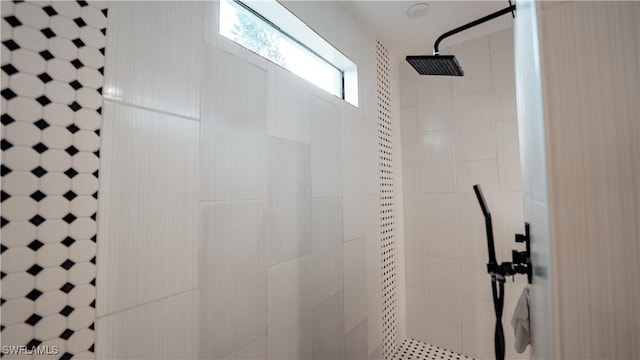 interior details featuring tiled shower