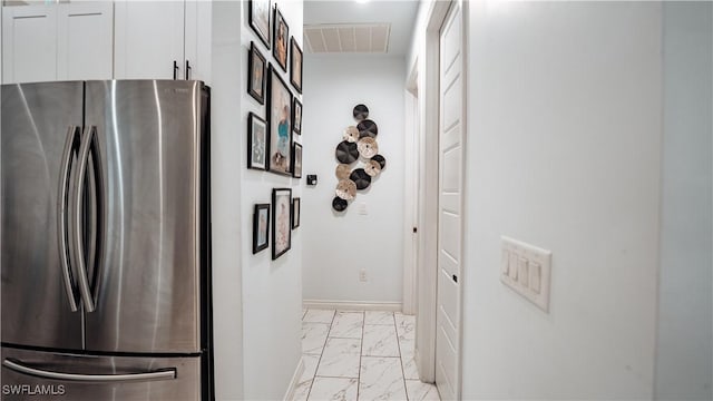 corridor featuring marble finish floor, visible vents, and baseboards