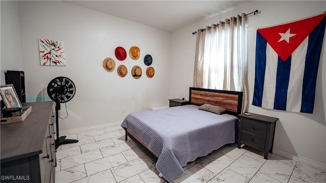 bedroom with marble finish floor and baseboards