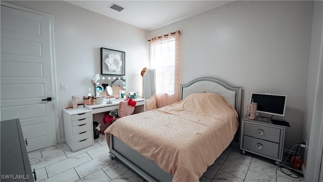 bedroom featuring marble finish floor and visible vents