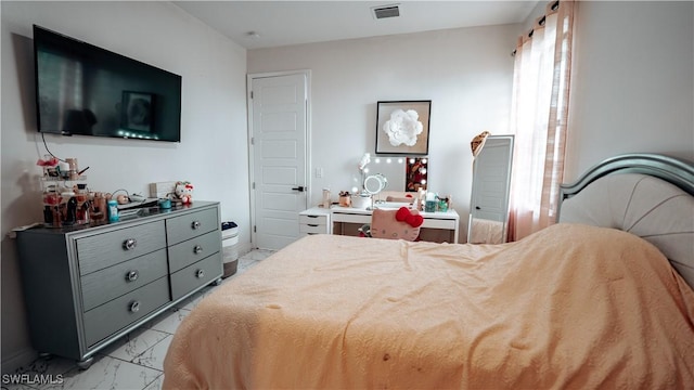 bedroom with marble finish floor and visible vents