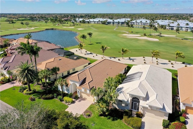 drone / aerial view with a residential view, a water view, and golf course view