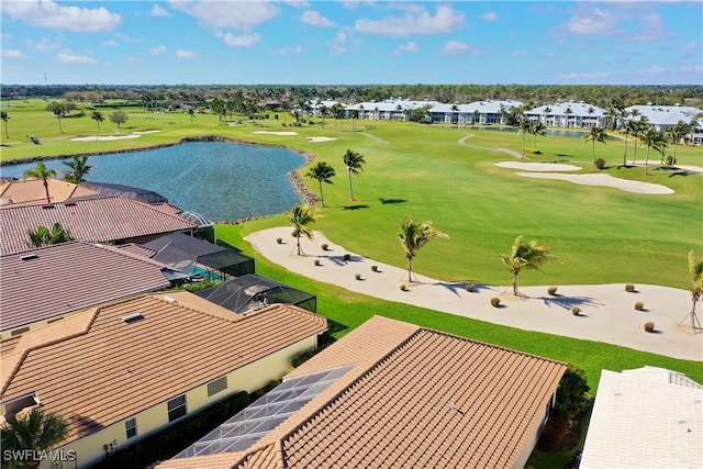 birds eye view of property with view of golf course and a water view