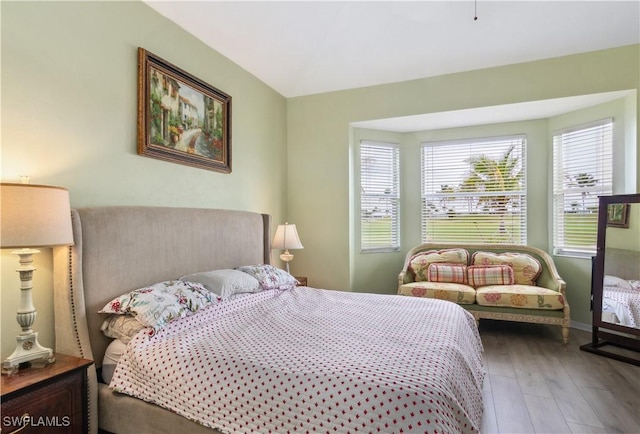 bedroom featuring baseboards and wood finished floors