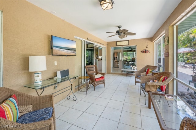 sunroom featuring a ceiling fan