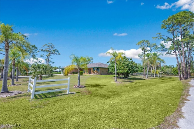 surrounding community featuring fence and a lawn