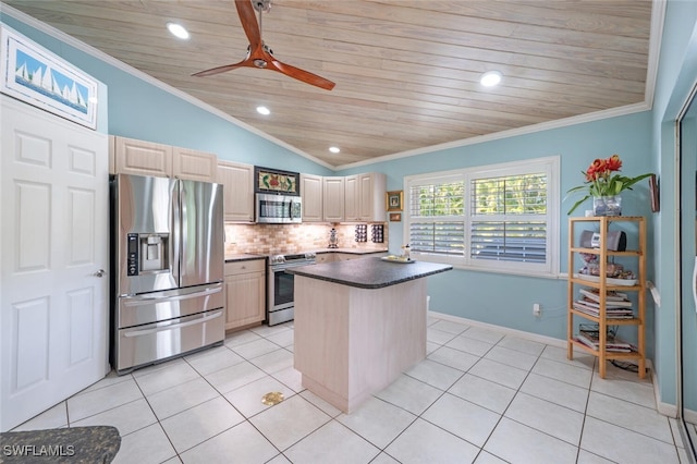 kitchen featuring light tile patterned floors, stainless steel appliances, lofted ceiling, decorative backsplash, and ornamental molding