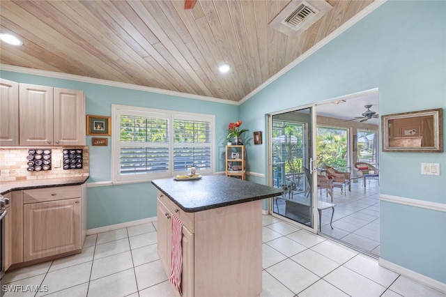 kitchen featuring light tile patterned floors, light brown cabinets, visible vents, and crown molding