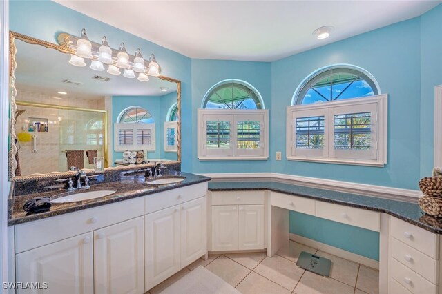 full bathroom featuring visible vents, a sink, a shower stall, and tile patterned floors