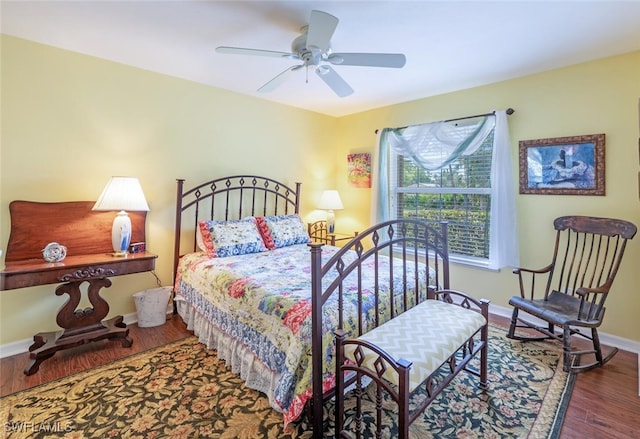 bedroom with wood finished floors, a ceiling fan, and baseboards