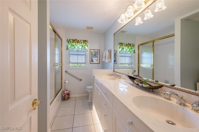 full bath featuring toilet, tile patterned flooring, double vanity, and a sink