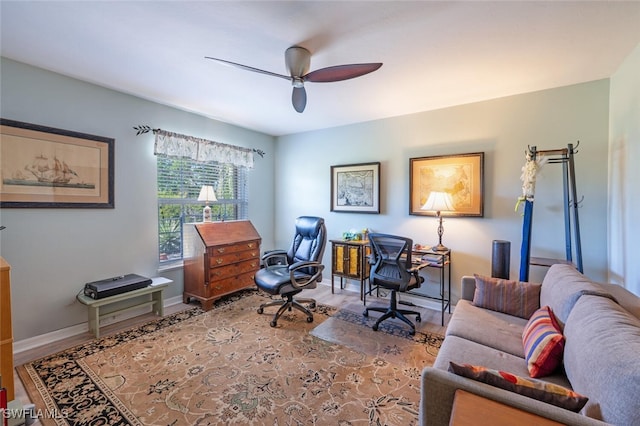 home office featuring baseboards, a ceiling fan, and wood finished floors