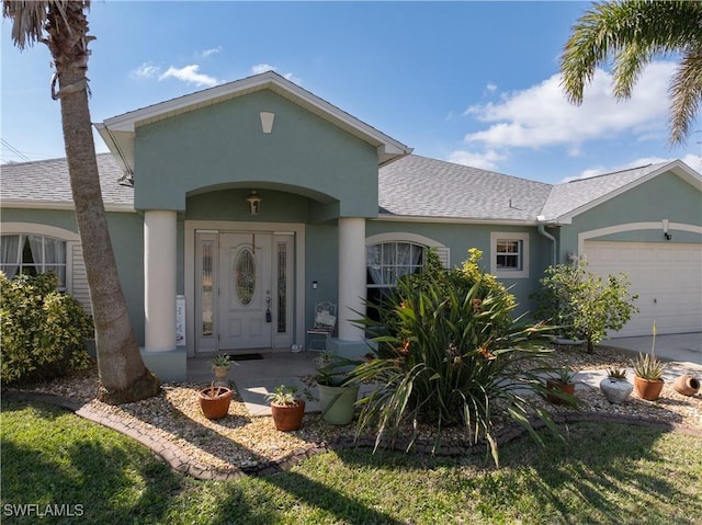 ranch-style house with an attached garage, a shingled roof, concrete driveway, and stucco siding