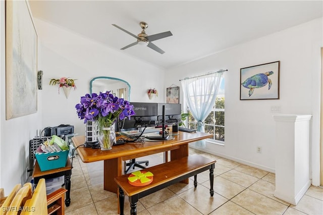 office area with ceiling fan, baseboards, and light tile patterned flooring