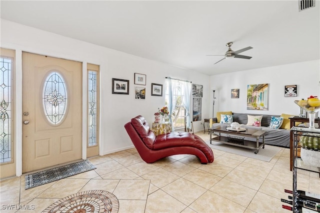 foyer entrance featuring baseboards, visible vents, a ceiling fan, and light tile patterned flooring