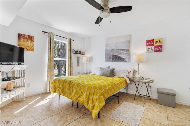 bedroom featuring baseboards, ceiling fan, and tile patterned floors