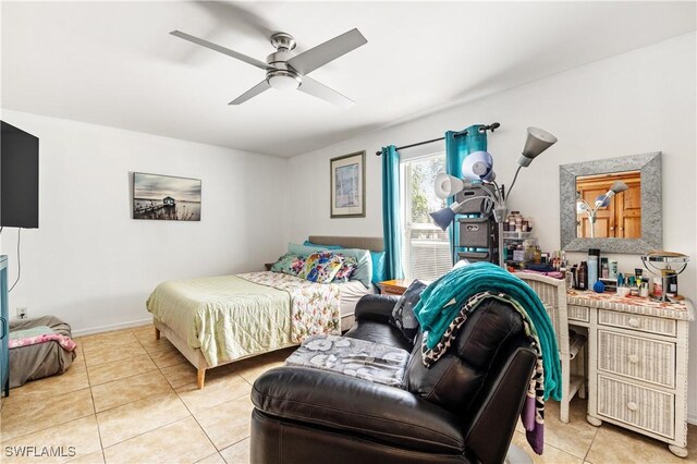 bedroom with light tile patterned floors, baseboards, and a ceiling fan