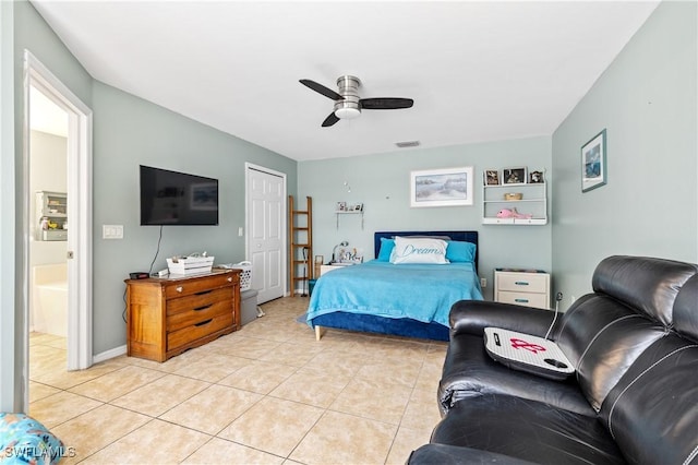 bedroom with light tile patterned flooring, ceiling fan, visible vents, and baseboards