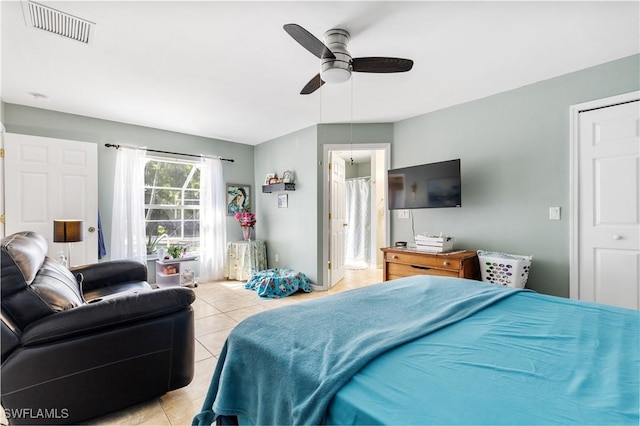 bedroom featuring light tile patterned floors, ceiling fan, and visible vents