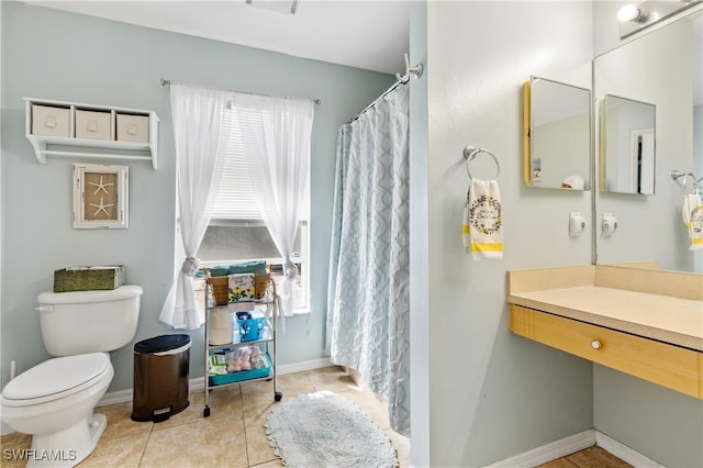 full bathroom featuring toilet, tile patterned flooring, baseboards, and a shower with shower curtain