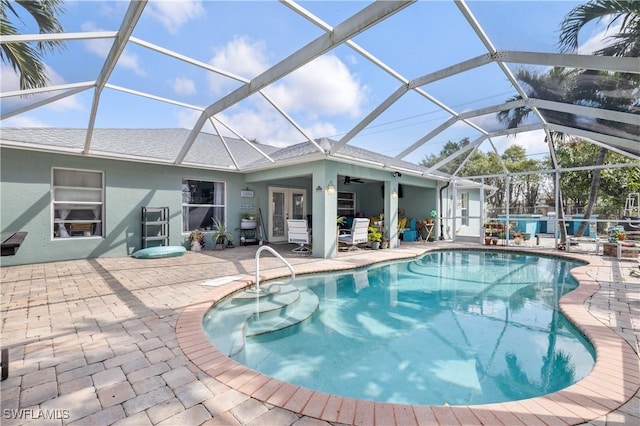 pool featuring a ceiling fan, french doors, glass enclosure, and a patio