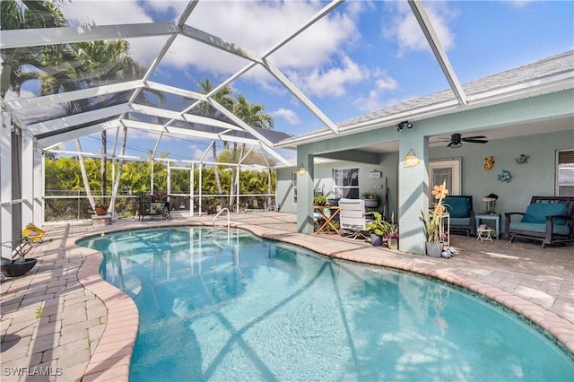 pool with a lanai, a patio area, and ceiling fan