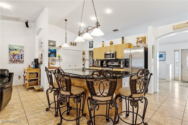 kitchen featuring light tile patterned floors, appliances with stainless steel finishes, a sink, and visible vents