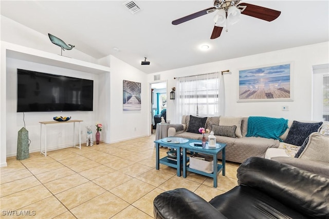 living area featuring light tile patterned floors, visible vents, baseboards, lofted ceiling, and ceiling fan