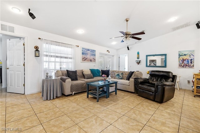 living room with light tile patterned floors, ceiling fan, vaulted ceiling, and visible vents