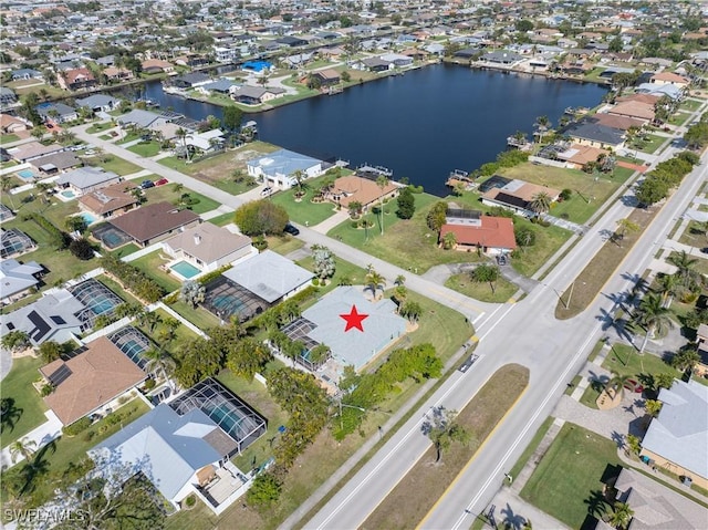 drone / aerial view featuring a water view and a residential view