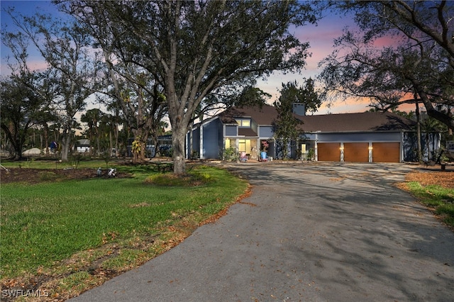 view of front of property with a front yard and driveway