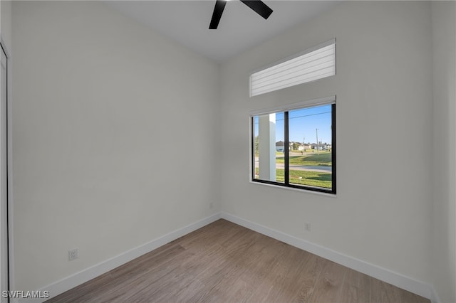 spare room with ceiling fan, baseboards, and wood finished floors