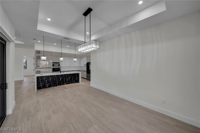 unfurnished living room featuring light wood-type flooring, baseboards, and recessed lighting