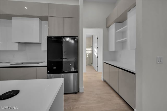 kitchen featuring open shelves, modern cabinets, and black electric cooktop