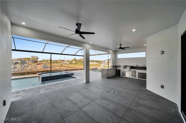 view of patio / terrace with ceiling fan, glass enclosure, exterior kitchen, and an outdoor pool