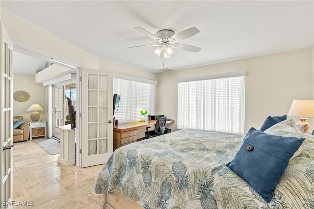 bedroom with stone finish floor, french doors, and ceiling fan