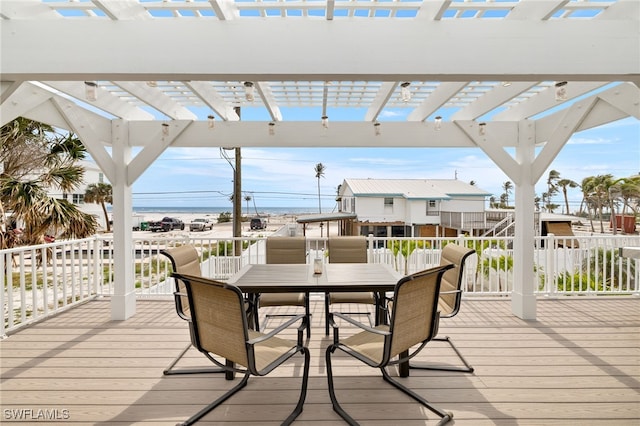 deck with outdoor dining area and a pergola