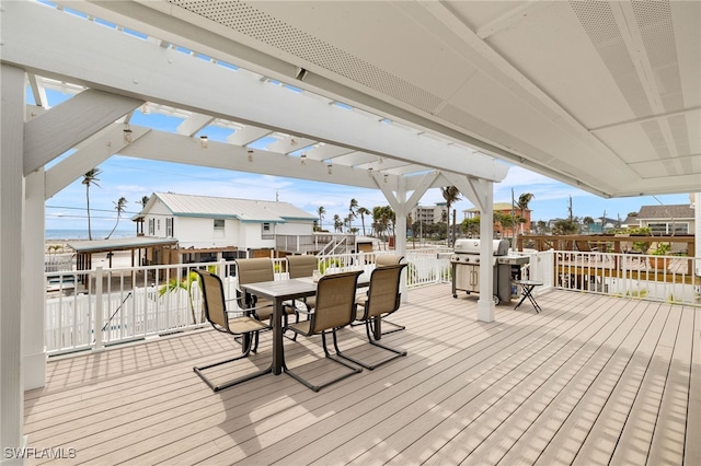 wooden terrace featuring outdoor dining area, a pergola, and grilling area