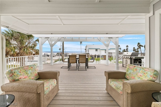 deck with outdoor dining area and a grill