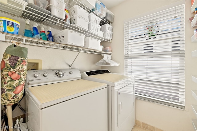 clothes washing area featuring washer and dryer and laundry area