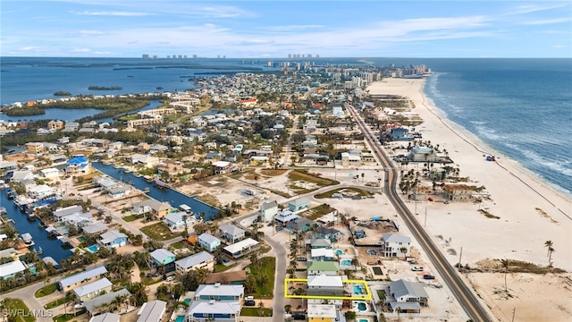 bird's eye view featuring a view of the beach and a water view