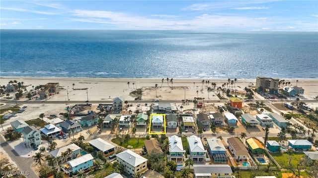 bird's eye view with a water view and a beach view