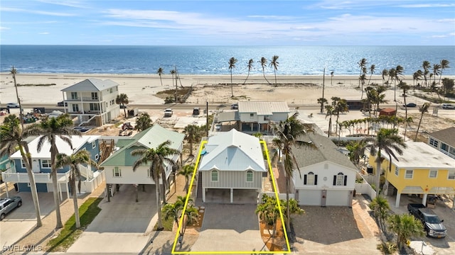 bird's eye view featuring a residential view, a water view, and a beach view